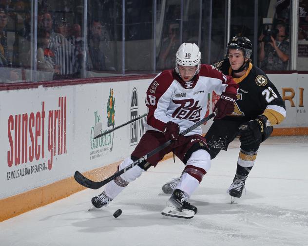 Peterborough Petes' Connor Lockhart battles Kingston Frontenacs' Duncan Schneider