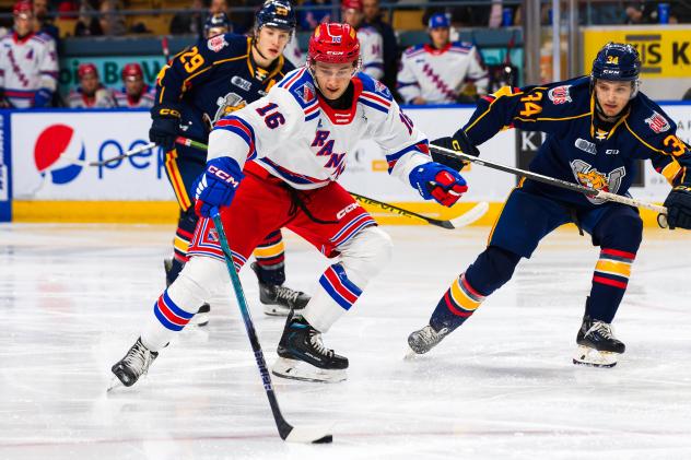 Kitchener Rangers' Carson Rehkopf and Barrie Colts' Cole Beaudoin and Olivier Savard in action