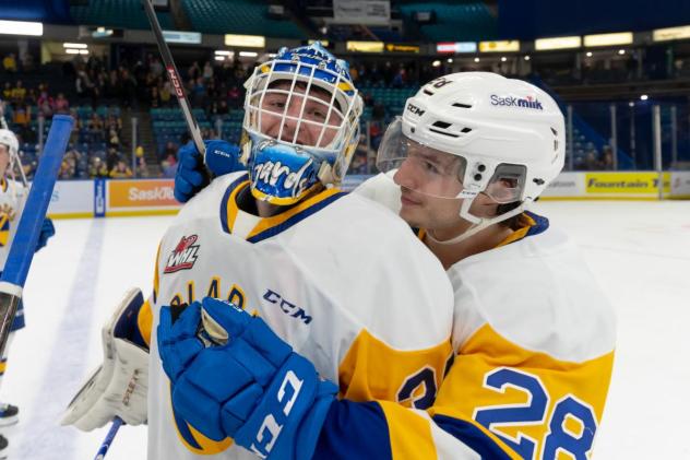 Saskatoon Blades' Evan Gardner and Lukas Hansen celebrate win