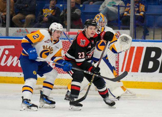Saskatoon Blades' Ben Saunderson versus Moose Jaw Warriors' Atlee Calvert