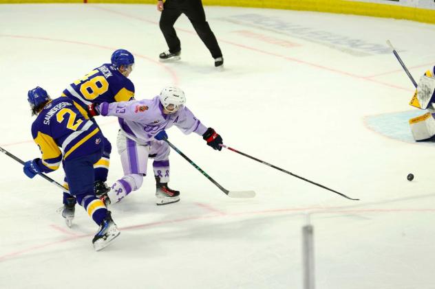 Saskatoon Blades' Ben Saunderson and Samuel Barcik battle Regina Pats' Hudson Kibblewhite