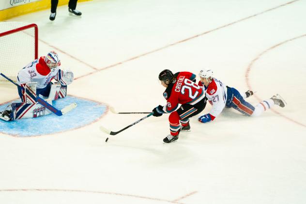 Kelowna Rockets' Andrew Cristall battles Spokane Chiefs' Cooper Michaluk and Berkly Catton