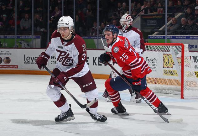 Peterborough Petes' Cam Gauvreau and Liam Sztuska and Oshawa Generals' Dylan Roobroeck on the ice