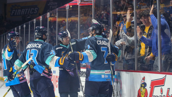 Toledo Walleye forward Sam Craggs is congratulated by teammates