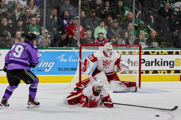 Grand Rapids Griffins' Sebastian Cossa and Josiah Didier and Texas Stars' Chase Wheatcroft on the ice
