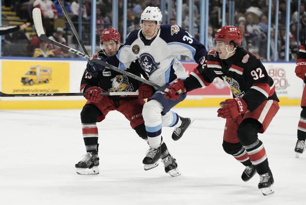 Milwaukee Admirals' Denis Gurianov battles Grand Rapids Griffins' Albert Johansson and Marco Kasper
