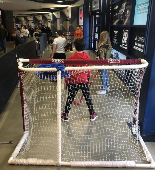 Kids play hockey at a Fayetteville Marksmen game