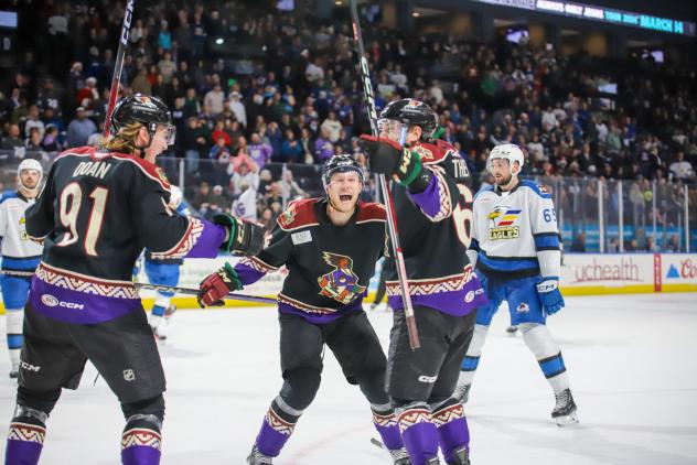 Tucson Roadrunners forwards Josh Doan, Jan Jenik, and Colin Theisen celebrate Josh Doan's game winning goal