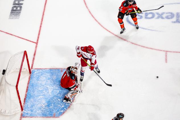 Allen Americans center Spencer Asuchak (center) looks for a shot
