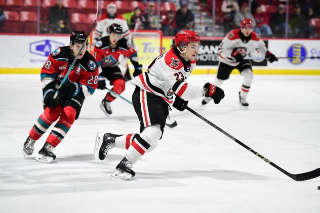 Kelowna Rockets' Andrew Cristall and Moose Jaw Warriors' Atley Calvert on the ice