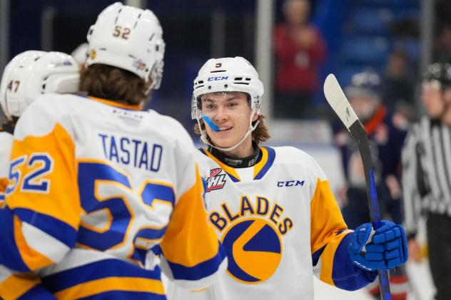 Saskatoon Blades' Morgan Tastad congratulates Rhett Melnyk