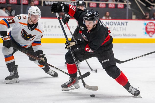 Lehigh Valley Phantoms' Adam Ginning and Charlotte Checkers' Jake Wise on the ice