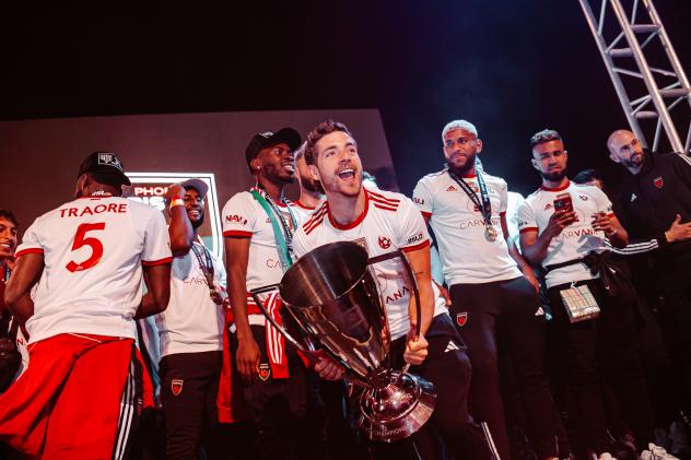 Phoenix Rising FC midfielder Emil Cuello Hoists the USL Championship trophy