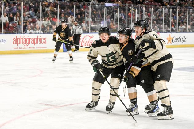 Utah Grizzlies defenseman Kyle Mayhew (left) and Brett Stapley (far right) vs. the Newfoundland Growlers