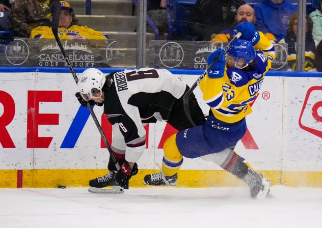 Vancouver Giants' Colton Roberts battkes Saskatoon Blades' Rowan Calvert