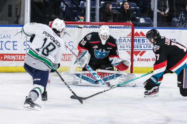 Seattle Thunderbirds' Sam Popowich battles Kelowna Rockets' Nathan Kam and Kayden Longley