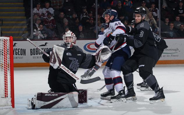 Peterborough Petes' Liam Sztuska and Cam Gauvreau versus Saginaw Spirit's Alex Christopoulos