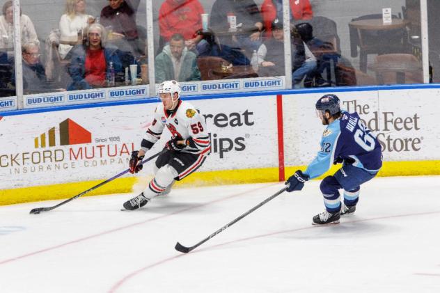 Rockford IceHogs defenseman Austin Strand (left)