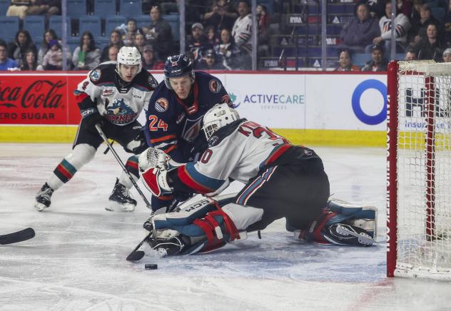 Kamloops Blazers' Blake Swetlikoff battles Kelowna Rockets' Caden Price and Jari Kykkanen