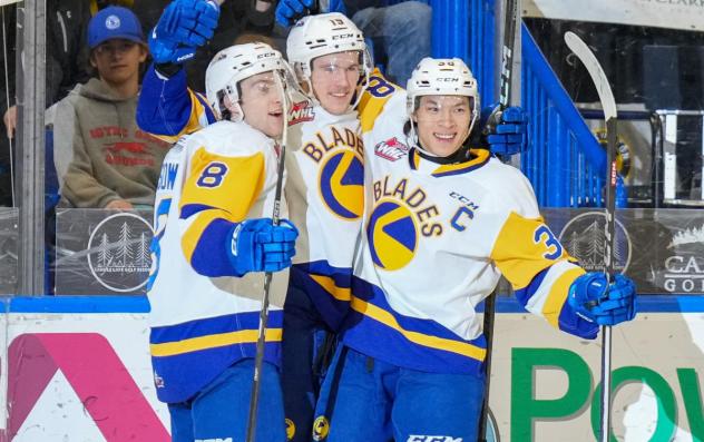 Saskatoon Blades' Brandon Lisowsky, Yegor Sidorov, and Trevor Wong celebrate win