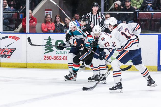 Kelowna Rockets' Hiroki Gojsic and Kamloops Blazers' Dylan Sydor and Ryan Michael in action