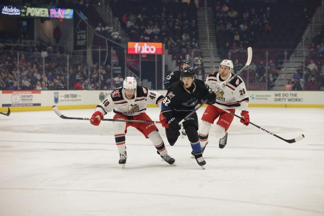 Grand Rapids Griffins' Wyatt Newpower and Tim Gettinger and Cleveland Monsters' Mikael Pyyhtia in action