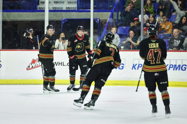 Vancouver Giants gather after a goal against the Spokane Chiefs