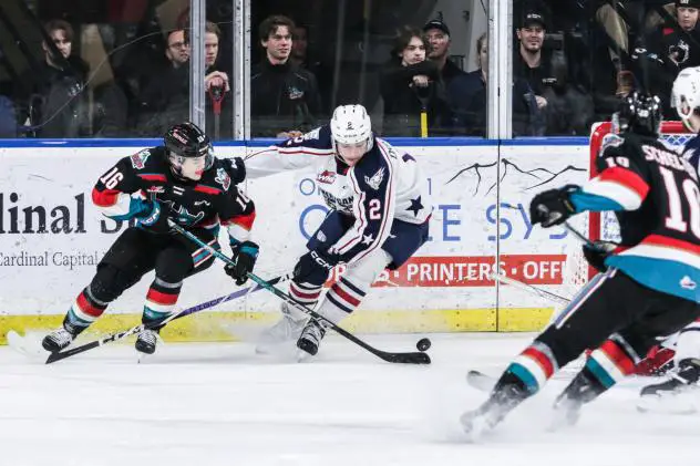 Kelowna Rockets left wing Ty Hurley (left) vs. the Tri-City Americans