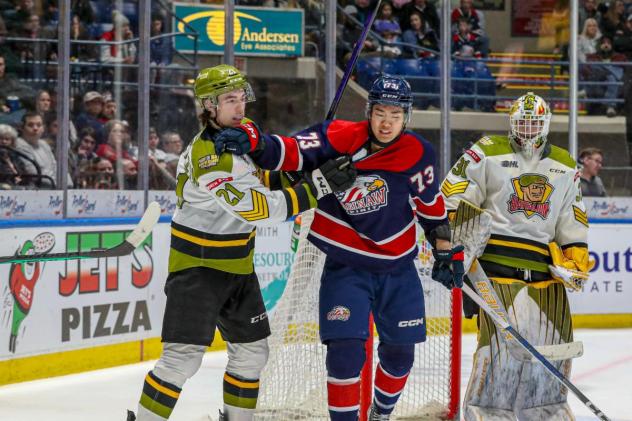 Saginaw Spirit's James Guo and North Bay Battalion's Ethan Procyszyn and Dom DiVincentiis on game night