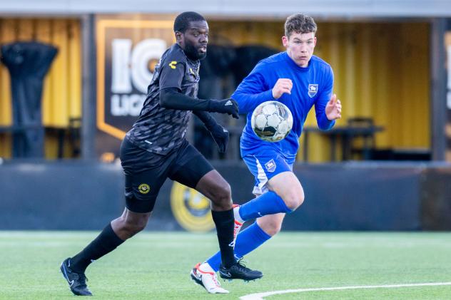 Pittsburgh Riverhounds SC captain Kenardo Forbes (left) vs. the University of Pittsburgh