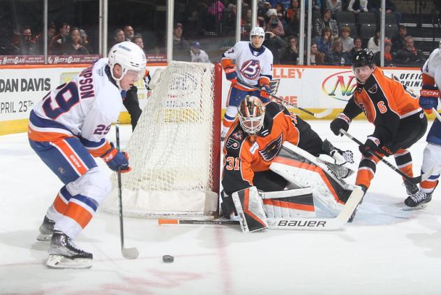 Bridgeport Islanders' Tyce Thompson and Lehigh Valley Phantoms' Parker Gahagen and Emil Andrae in action
