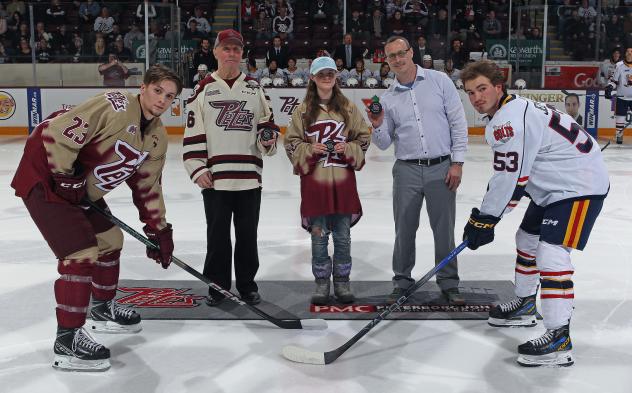 Peterborough Petes' Jonathan Melee, Barrie Colts' Beau Jelsma, and Petes' Real Canadian Superstore winning jersey designer Hana Bates-Keegan on game night