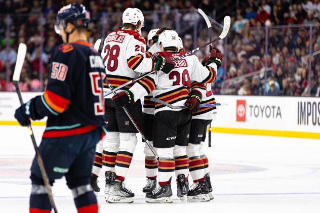 Tucson Roadrunners' Curtis Douglas and Cameron Hebig celebrate with teammates
