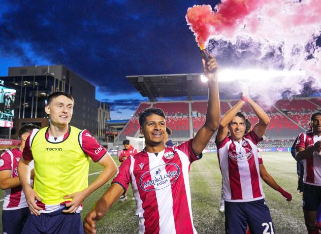 Atlético Ottawa winger Zach Verhoven (center) celebrating Atlético's home win against Cavalry FC in July 2023