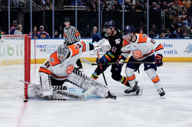 Greenville Swamp Rabbits' Jacob Ingham and Jake Flynn battle Jacksonville Icemen's Garrett Van Wyhe