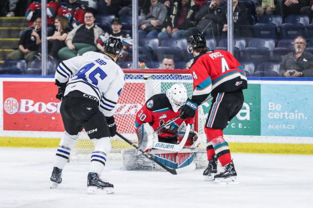 Wenatchee Wild's Steven Arp versus Kelowna Rockets' Jari Kykkanen and Caden Price