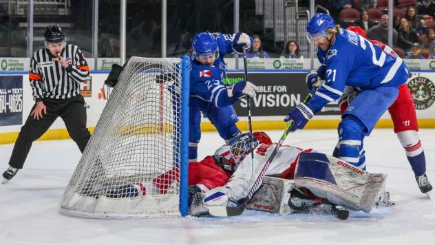 Wichita Thunder tries to poke the puck past the Allen Americans