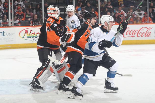 Lehigh Valley Phantoms' Cal Petersen and Louie Belpedio and Cleveland Monsters' Kent Johnson on game night