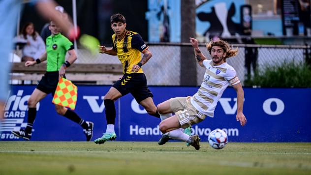 Charleston Battery's Nick Markanich and Louisville City FC's Kyle Adams in action