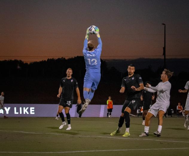 South Georgia Tormenta FC goalkeeper Drew Romig goes high to make a stop
