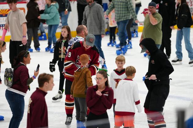Tucson Roadrunners forward Cameron Hebig skates with fans