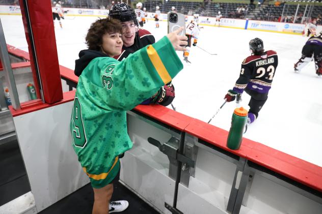 Tucson Roadrunners forward Cameron Hebig with a fan