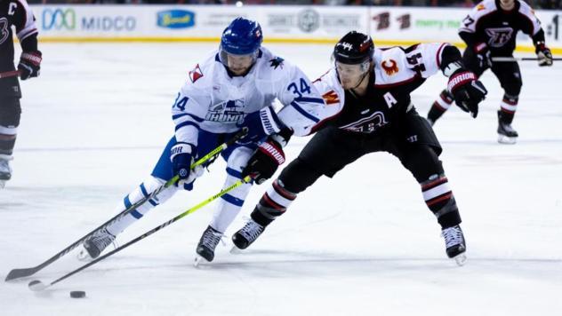 Wichita Thunder forward Jason Pineo (left) vs. the Rapid City Rush