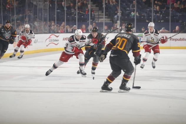 Grand Rapids Griffins chase the puck against the Chicago Wolves