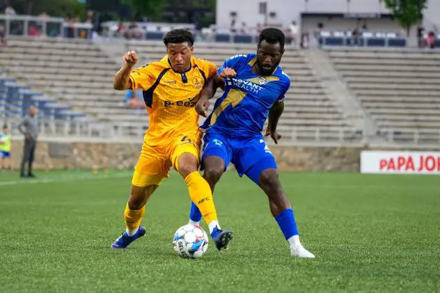 Rhode Island FC's Collin Smith battles Charlotte Independence's Fabrice Ngah