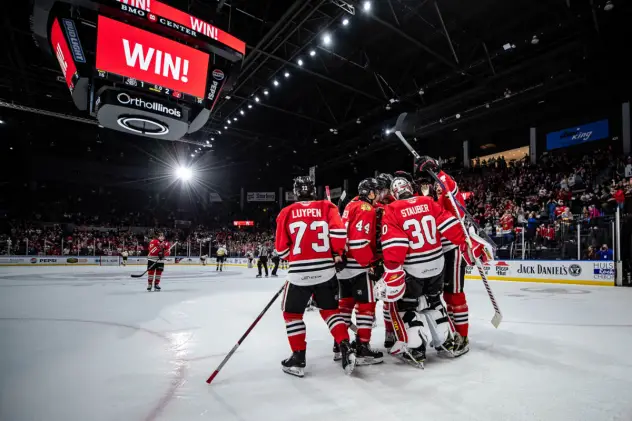 Rockford IceHogs gather after a win