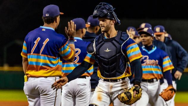 Montgomery Biscuits' Kevin Piper congratulates Heriberto Hernandez