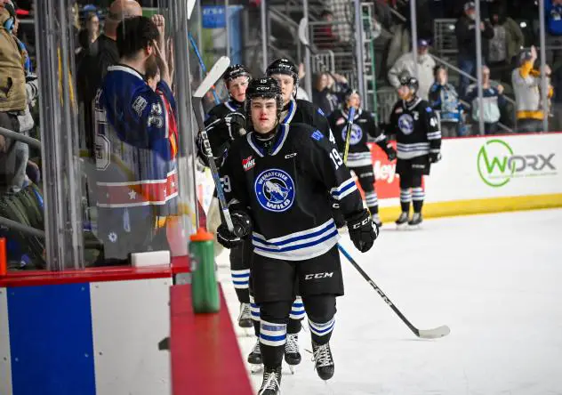 Miles Cooper (front) leads his Wenatchee Wild teammates on a victory lap