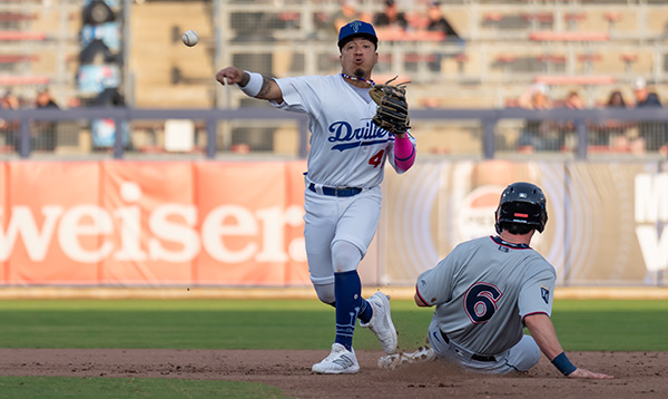 Tulsa Drillers' Yeiner Fernandez and Northwest Arkansas Naturals' Cayden Wallace in action