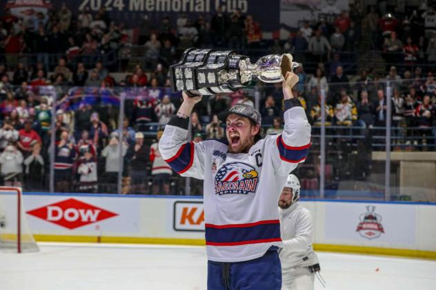 Saginaw Spirit defenseman Braden Haché hoists the Memorial Cup